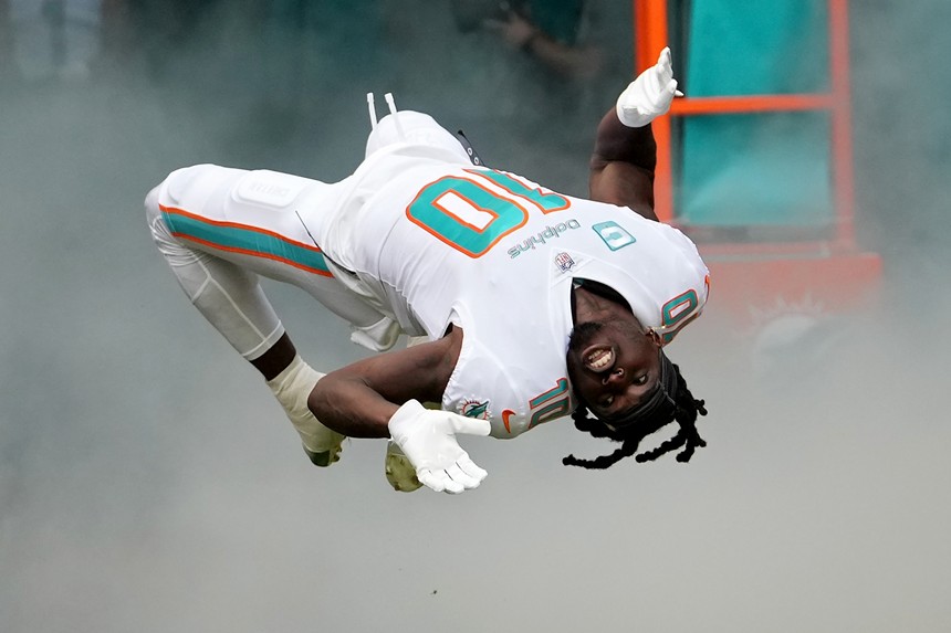 NFL receiver Tyreek Hill does a flip during his entrance onto the field